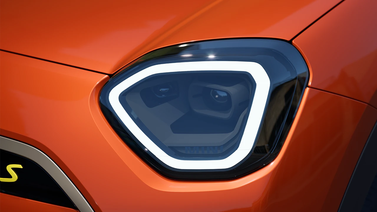 Detail view of the all-electric MINI Aceman headlight with white light on