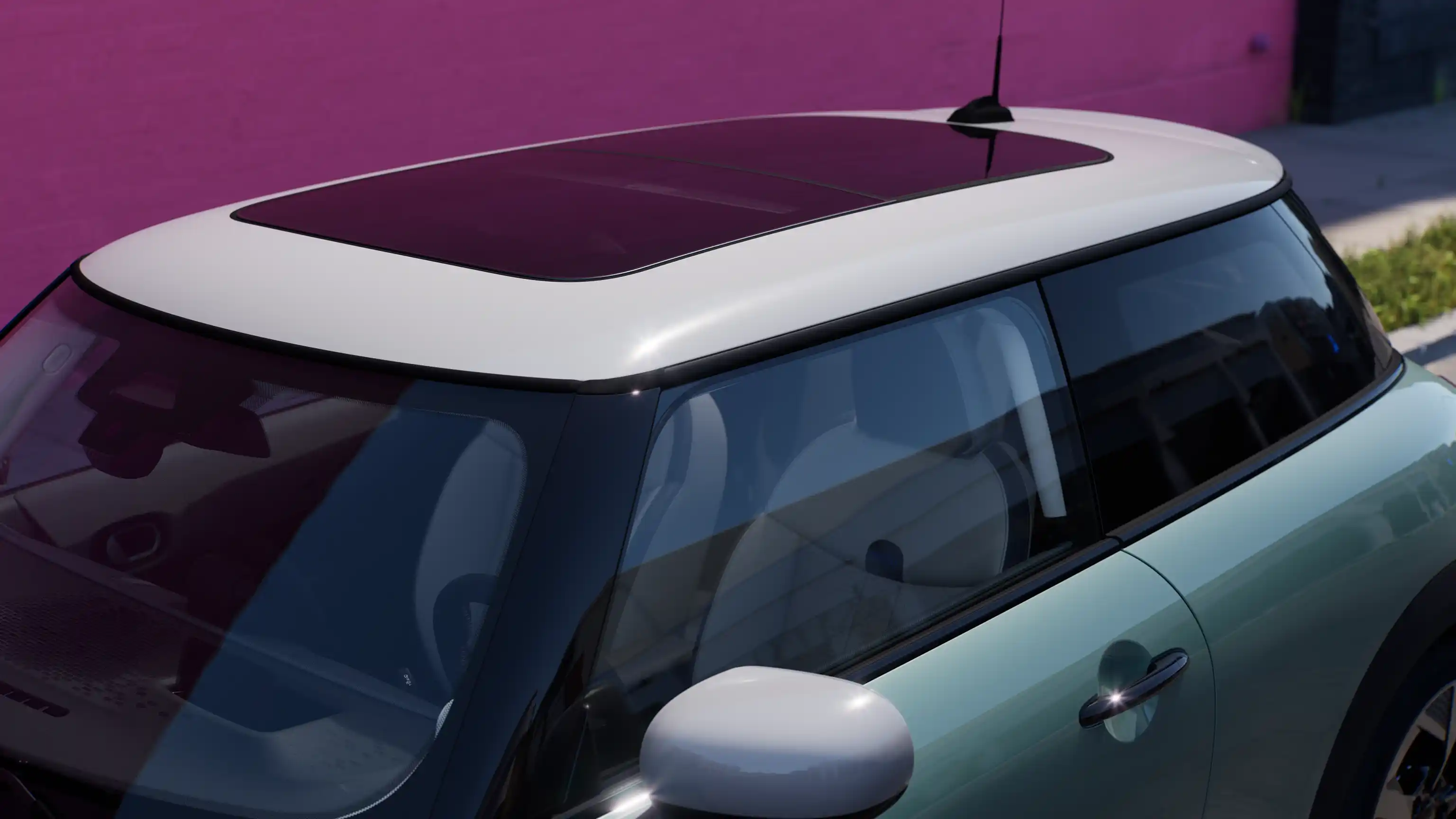 Top view of the MINI Cooper in Ocean Wave Green with with contrast roof and big glass roof.