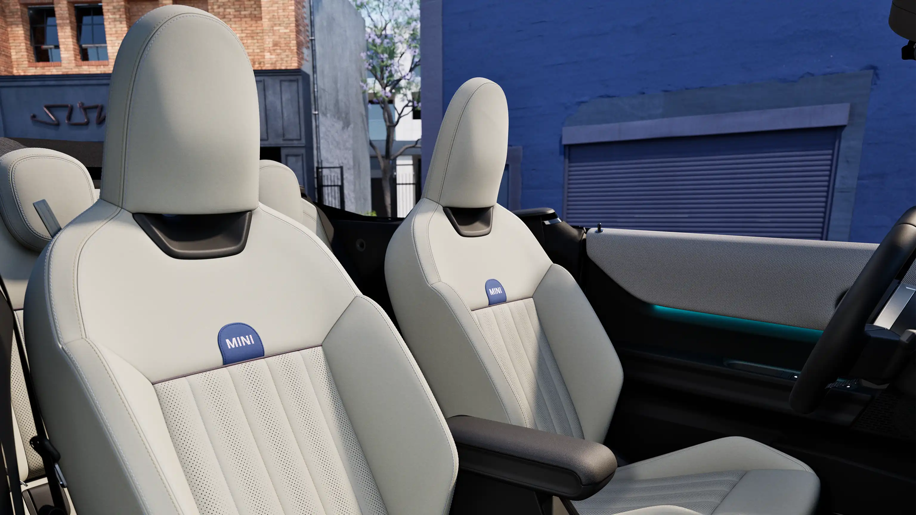 Interior perspective of the MINI Cooper Convertible  is showing the dashboard, steering wheel, round display and back of the frontseats.