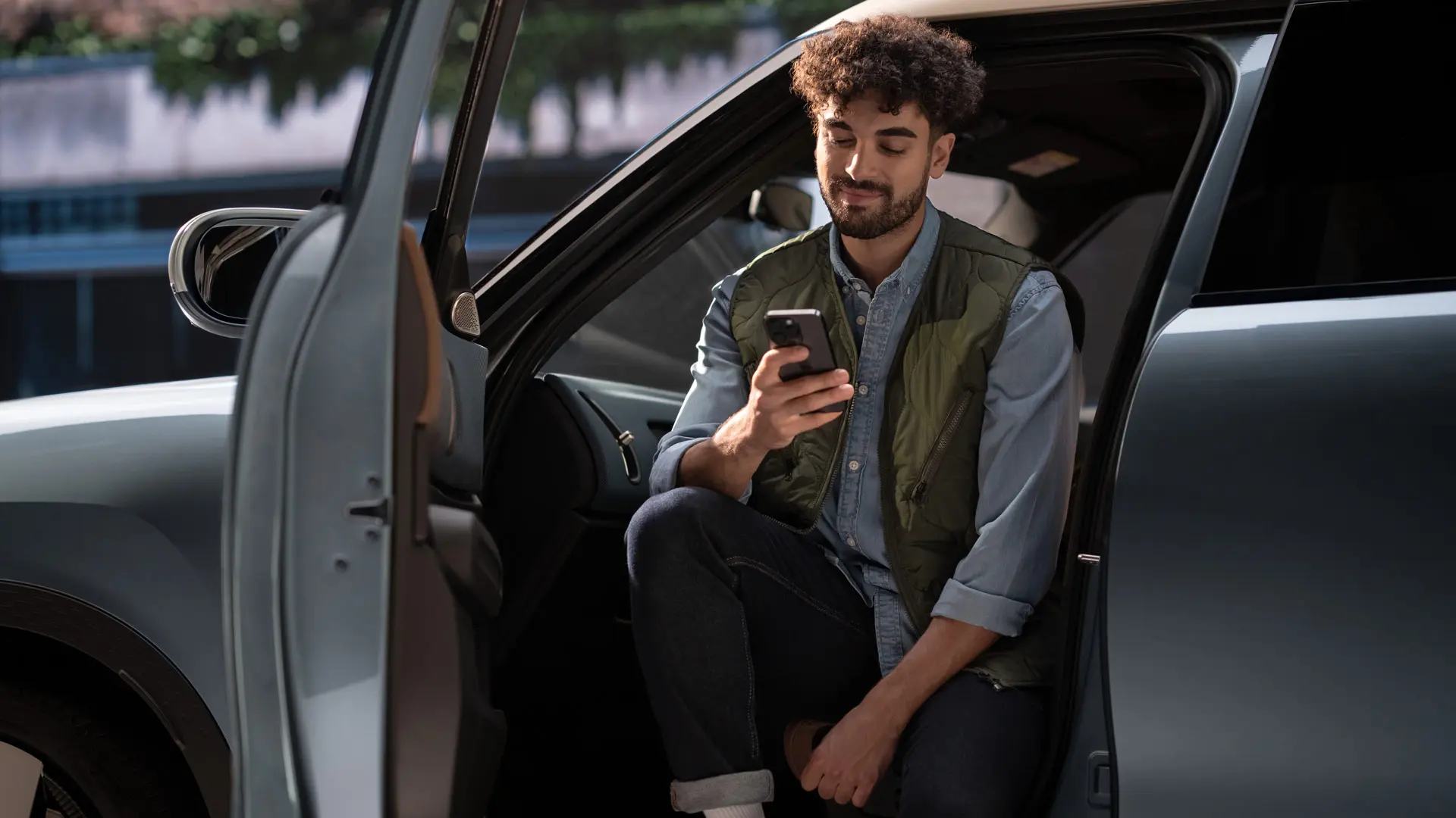 A man booking a service appointment using his mobile phone.