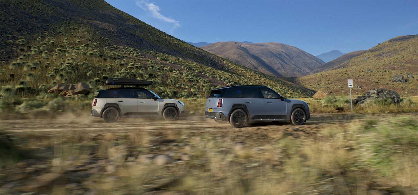 Image of two MINI Countryman Untamed Edition vehicles driving from the back.